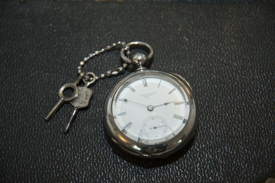 A key-wound pocket watch and its keys